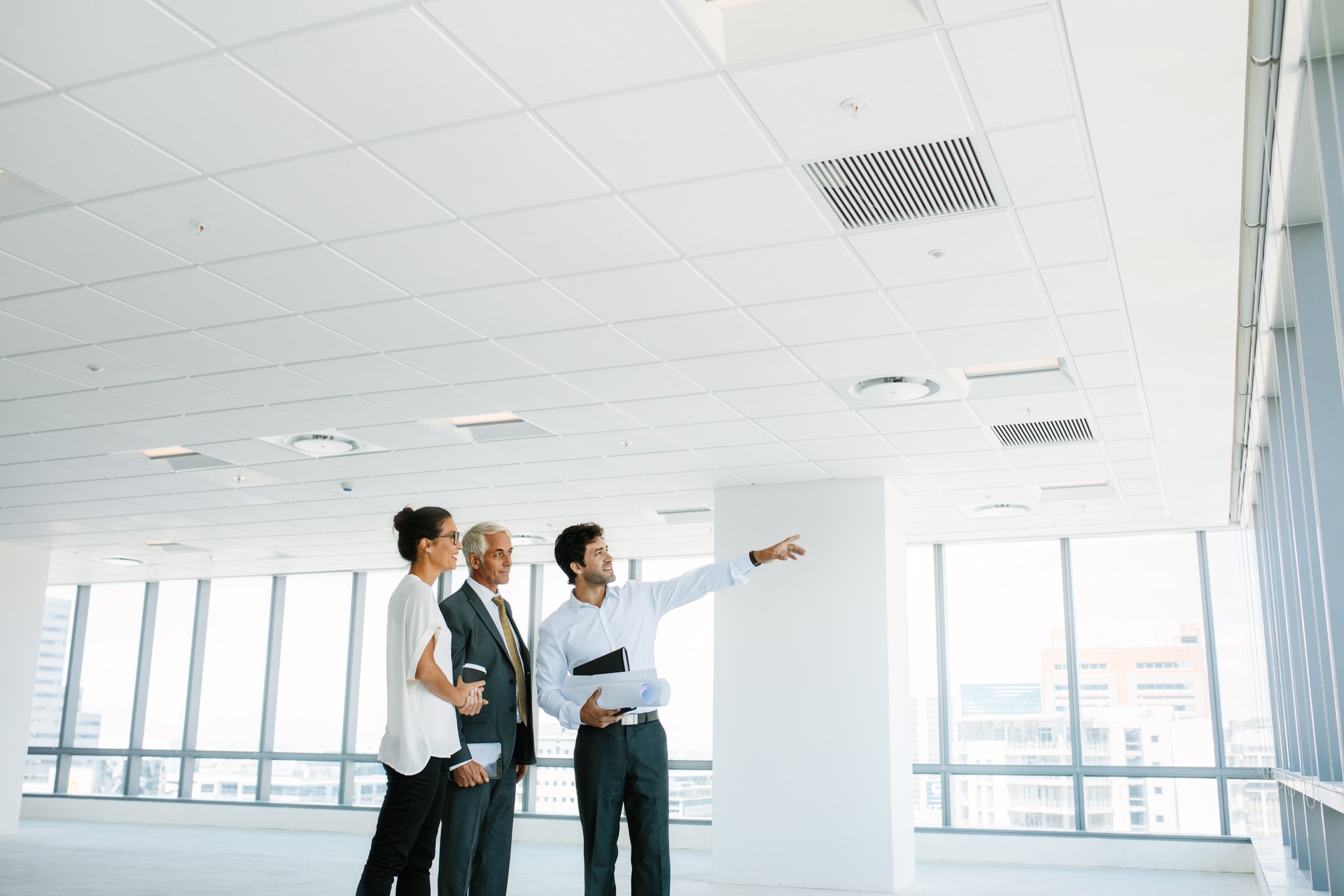 Real estate broker showing office space to clients